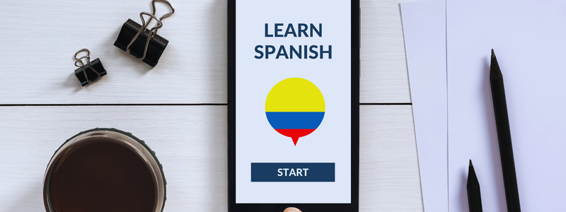 Smartphone displaying 'Learn Spanish' app interface featuring the Colombian flag, inviting users to start their language journey with 'Spanish from Zero'—an invitation offered by Colombia Spanish in Medellín, ideal for English speakers looking to learn Spanish in Colombia.