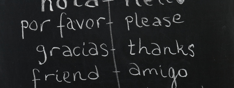 Embrace the journey of 'Spanish Immersion' with Colombia Spanish, as displayed on a chalkboard, bridging English and Spanish for eager learners in Medellín, Colombia.